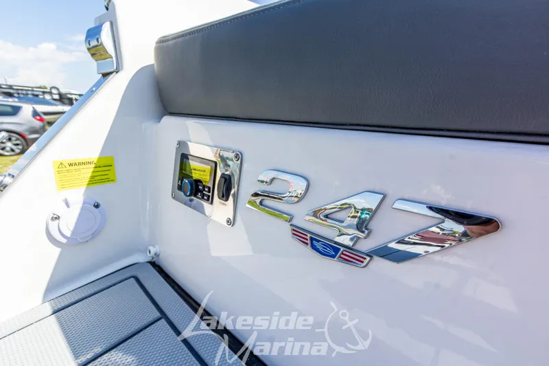 Slide: The Image of 2025 Chaparral 247 SSX boat interior with logo and control panel. - 13