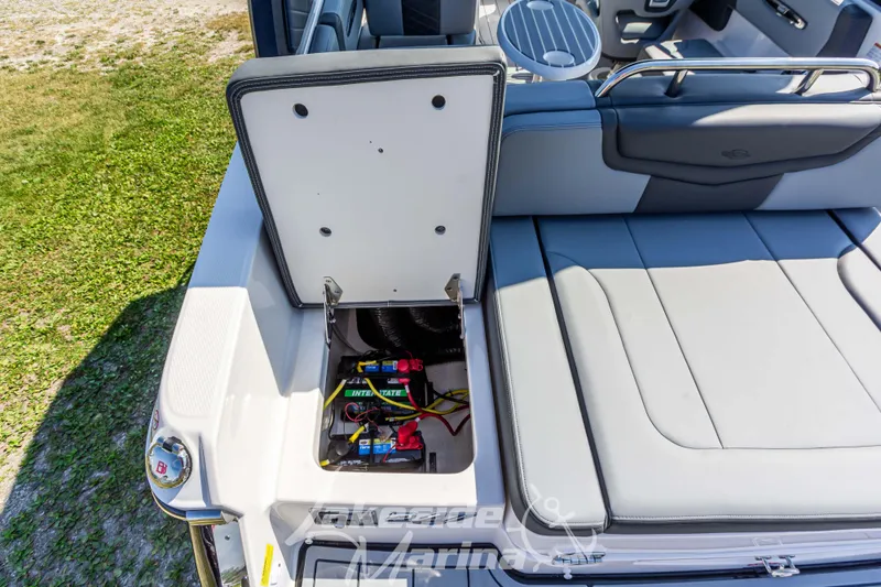 Slide: The Image of 2025 Chaparral 247 SSX boat with open storage compartment, revealing battery setup. - 14