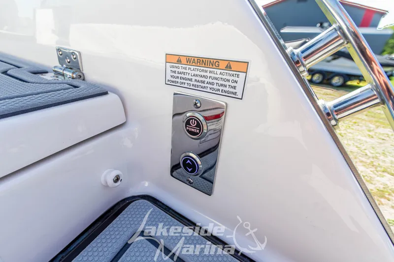 Slide: The Image of 2025 Chaparral 247 SSX boat control panel with warning label and power button. - 15