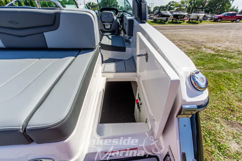 Slide: The Image of 2025 Chaparral 247 SSX boat interior with open storage compartment and seating. - 16