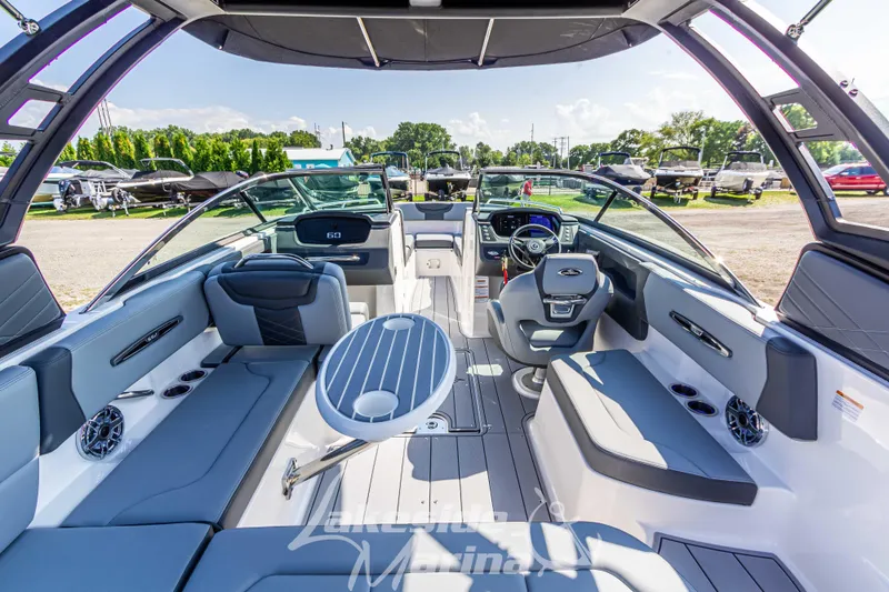 Slide: The Image of 2025 Chaparral 247 SSX boat interior with sleek seating and modern dashboard. - 17