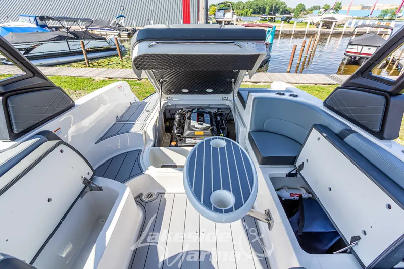 Slide: The Image of 2025 Chaparral 247 SSX boat interior with open engine compartment and seating area. - 20