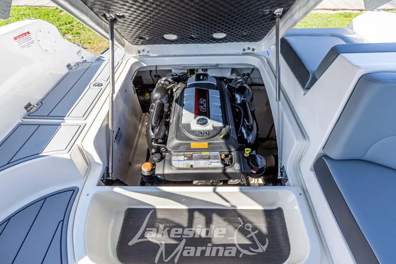 Slide: The Image of 2025 Chaparral 247 SSX boat engine compartment, open hatch, detailed view. - 21