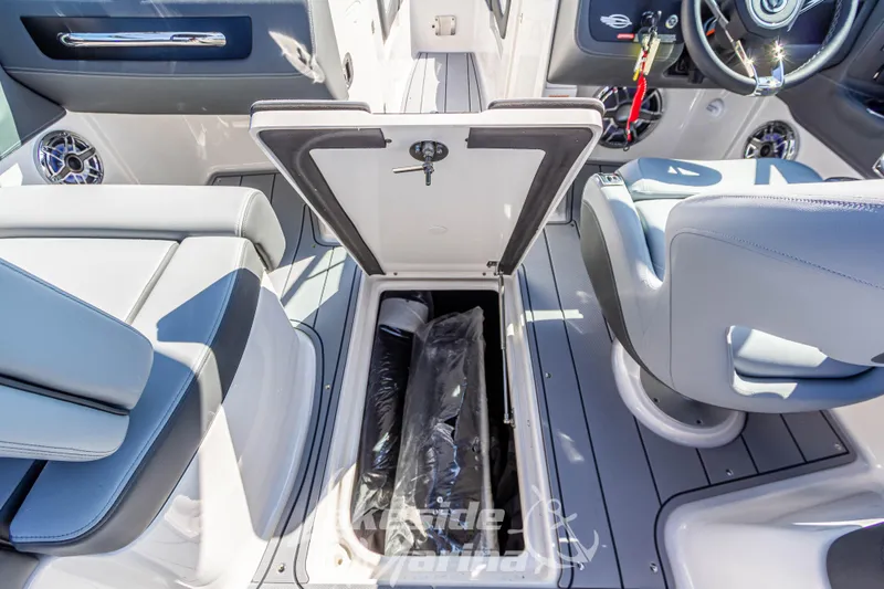 Slide: The Image of 2025 Chaparral 247 SSX boat interior with open storage compartment. - 22