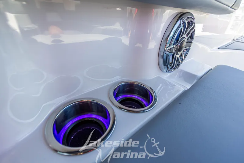 Slide: The Image of 2025 Chaparral 247 SSX boat interior with illuminated cup holders and speaker. - 23