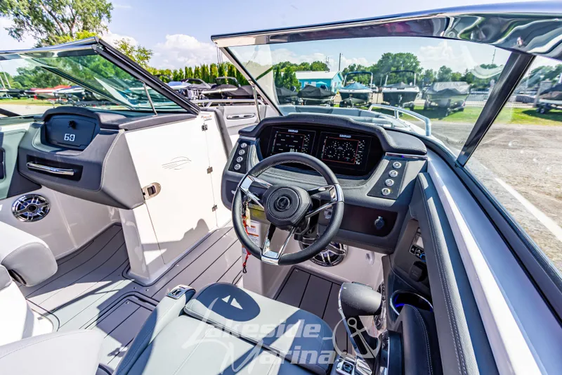Slide: The Image of 2025 Chaparral 247 SSX boat interior with modern dashboard and steering wheel. - 24