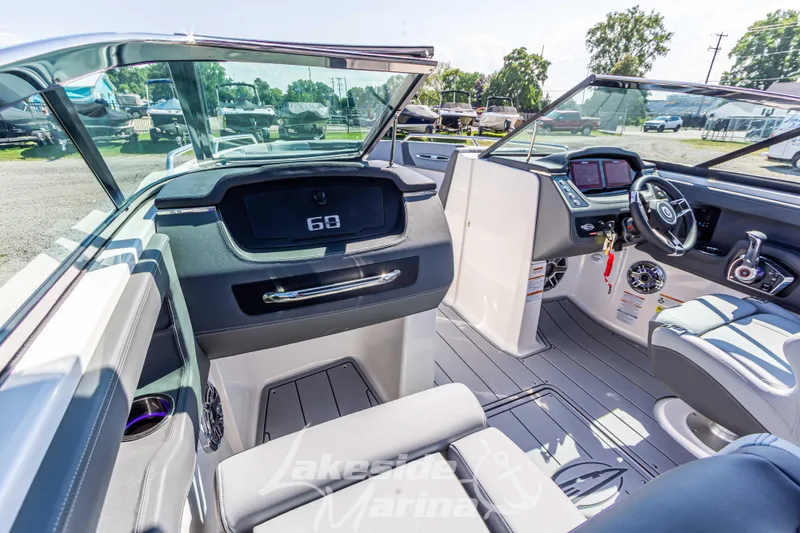 Slide: The Image of 2025 Chaparral 247 SSX boat interior with modern dashboard and seating. - 26