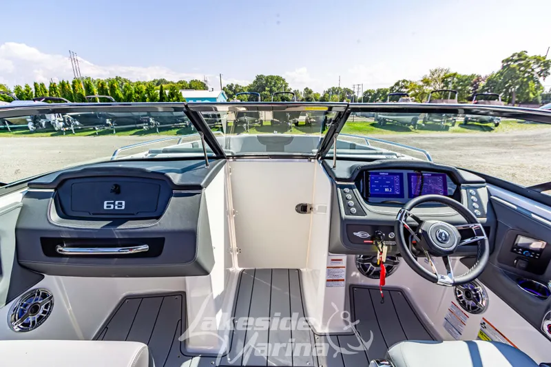 Slide: The Image of 2025 Chaparral 247 SSX boat interior with modern dashboard and steering wheel. - 31