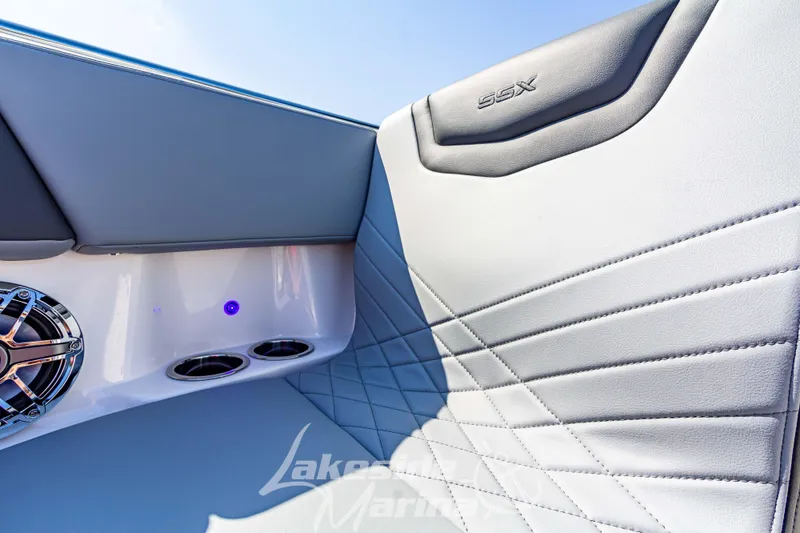 Slide: The Image of 2025 Chaparral 247 SSX boat interior with sleek upholstery and modern speaker design. - 38