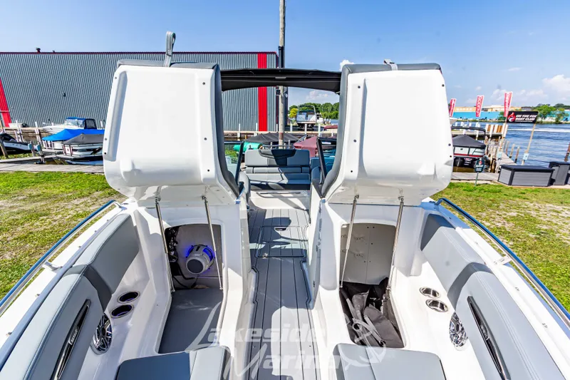 Slide: The Image of 2025 Chaparral 247 SSX boat interior with open storage compartments, dockside view. - 39