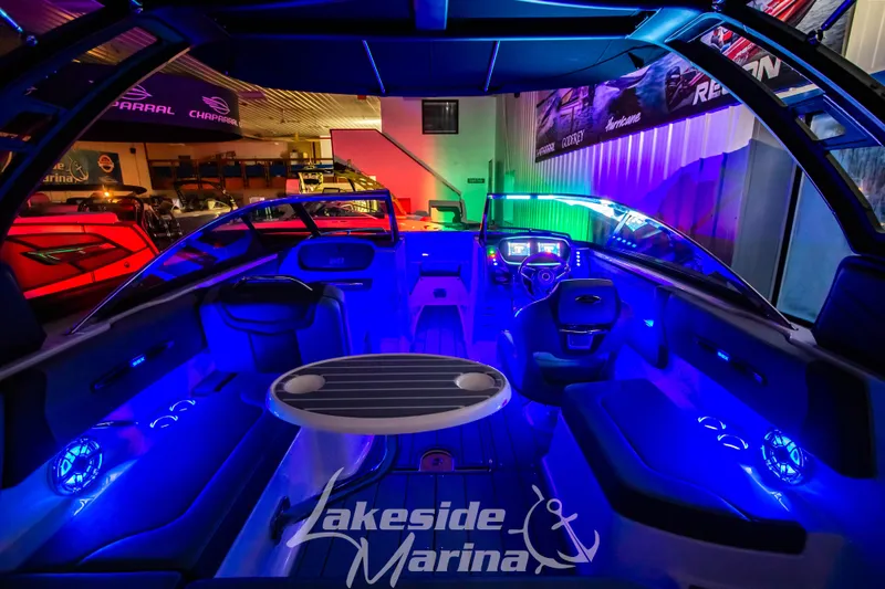 Slide: The Image of 2025 Chaparral 247 SSX boat interior with vibrant blue LED lighting at Lakeside Marina. - 40