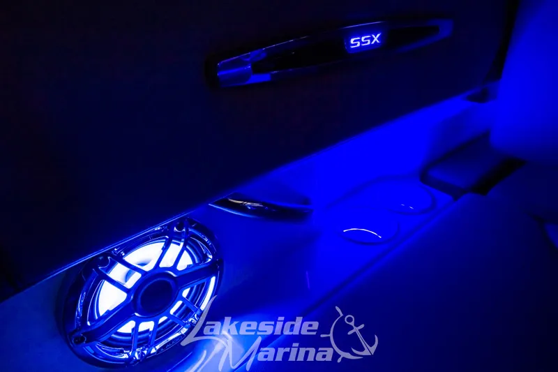Slide: The Image of 2025 Chaparral 247 SSX boat interior with blue LED lighting and speaker system. - 41