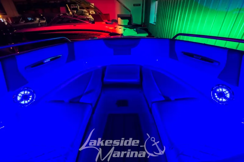 Slide: The Image of 2025 Chaparral 247 SSX boat interior with vibrant blue LED lighting at Lakeside Marina. - 45