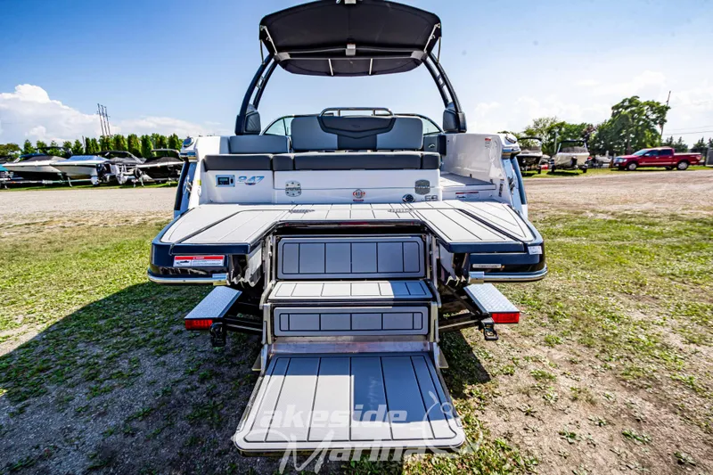 Slide: The Image of 2025 Chaparral 247 SSX boat with open swim platform and seating, displayed outdoors. - 5