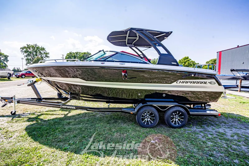Slide: The Image of 2025 Chaparral 247 SSX boat on trailer, sleek design, parked outdoors. - 8