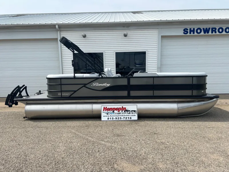 Slide: The Image of 2025 Bentley Pontoons Legacy Navigator in front of a showroom. - 0