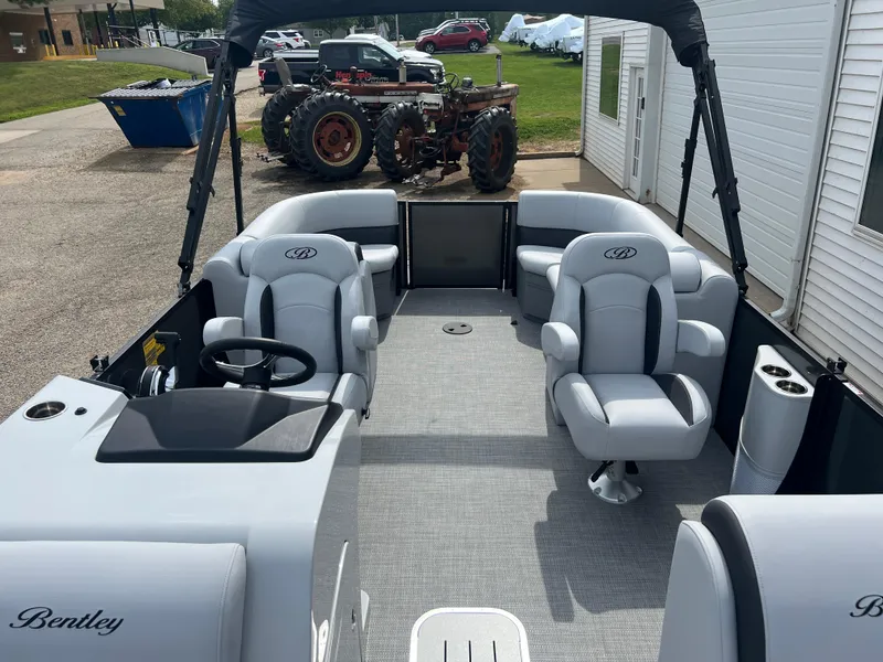 Slide: The Image of 2025 Bentley Pontoons Legacy Navigator interior with plush seating and modern design. - 11