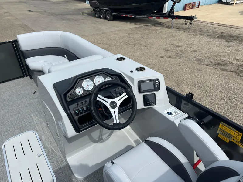 Slide: The Image of 2025 Bentley Pontoons Legacy Navigator boat interior with modern dashboard and steering wheel. - 13
