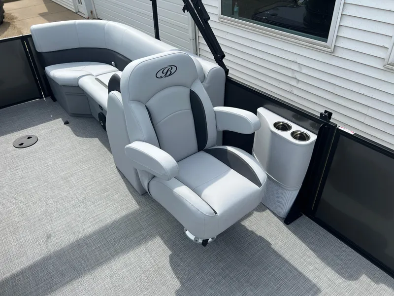 Slide: The Image of 2025 Bentley Pontoons Legacy Navigator interior with plush seating and cup holders. - 14