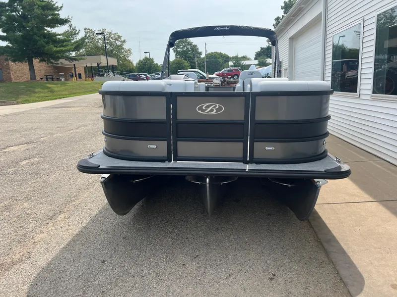 Slide: The Image of 2025 Bentley Pontoons Legacy Navigator, sleek design, parked on a sunny street. - 2