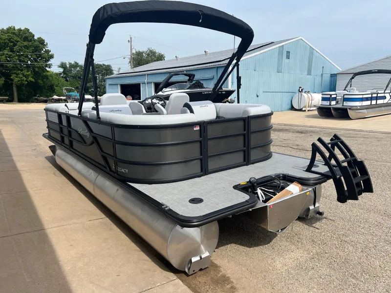 Slide: The Image of 2025 Bentley Pontoons Legacy Navigator, sleek design, docked at marina. - 4