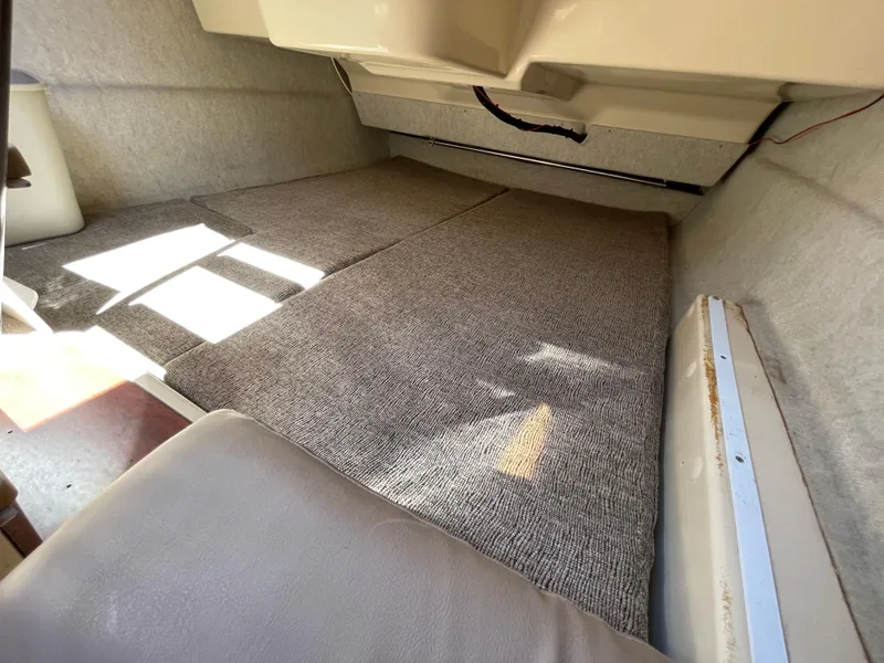 Slide: The Image of Interior cabin of a 2006 MacGregor 26M sailboat with carpeted flooring. - 19