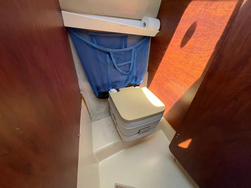 Slide: The Image of Compact bathroom in 2006 MacGregor 26M sailboat with portable toilet and storage. - 20