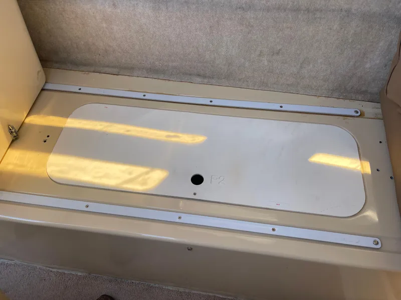 Slide: The Image of Interior storage compartment of a 2006 MacGregor 26M boat. - 23