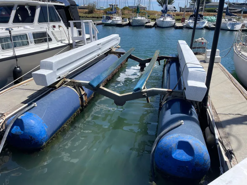 Slide: The Image of Boat lift at marina with blue pontoons, designed for a 2006 MacGregor 26M sailboat. - 25