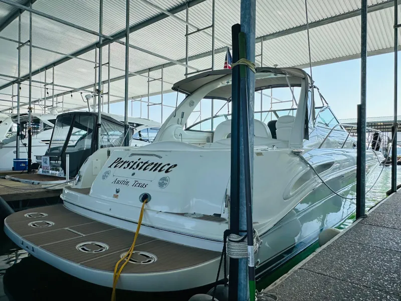 Slide: The Image of 2002 Sea Ray 410 Express Cruiser docked in marina, named "Persistence," Victoria, Texas. - 10