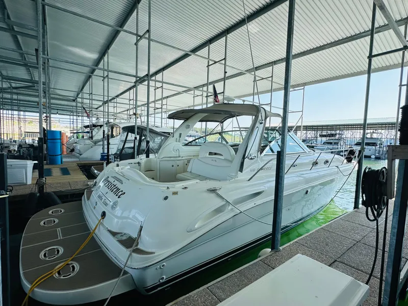 Slide: The Image of 2002 Sea Ray 410 Express Cruiser docked in marina, side view. - 11