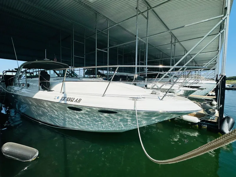Slide: The Image of 2002 Sea Ray 410 Express Cruiser docked in marina. - 12