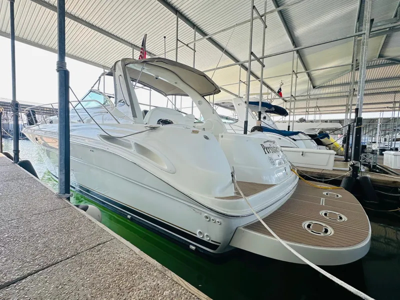 Slide: The Image of 2002 Sea Ray 410 Express Cruiser docked in a covered marina. - 13