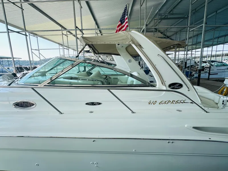 Slide: The Image of 2002 Sea Ray 410 Express Cruiser docked under a covered marina. - 15