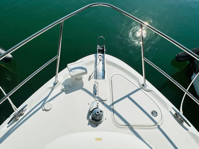 Slide: The Image of Bow of 2002 Sea Ray 410 Express Cruiser on calm water. - 16