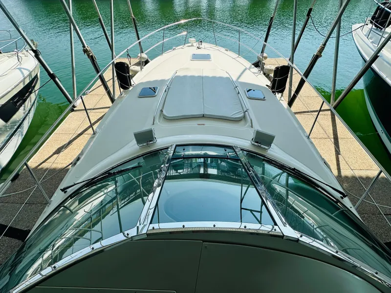 Slide: The Image of 2002 Sea Ray 410 Express Cruiser docked, top view of sleek design and spacious deck. - 17