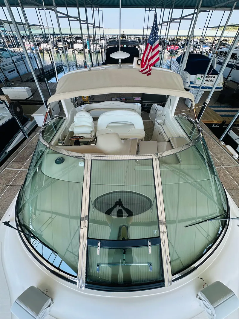Slide: The Image of 2002 Sea Ray 410 Express Cruiser with American flag, docked in marina. - 18