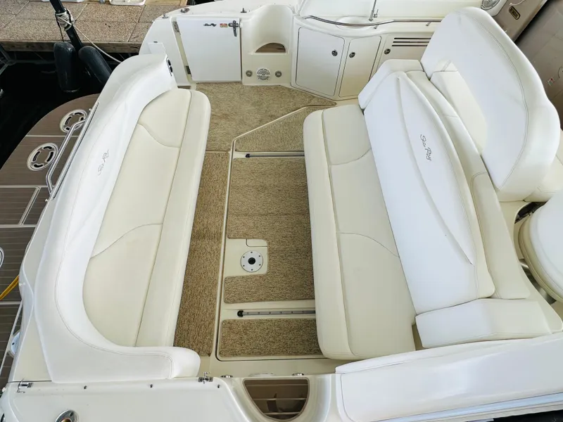 Slide: The Image of 2002 Sea Ray 410 Express Cruiser interior with white seating and carpeted flooring. - 21