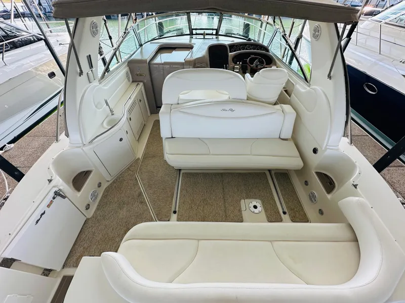 Slide: The Image of 2002 Sea Ray 410 Express Cruiser interior with white seating and helm. - 22