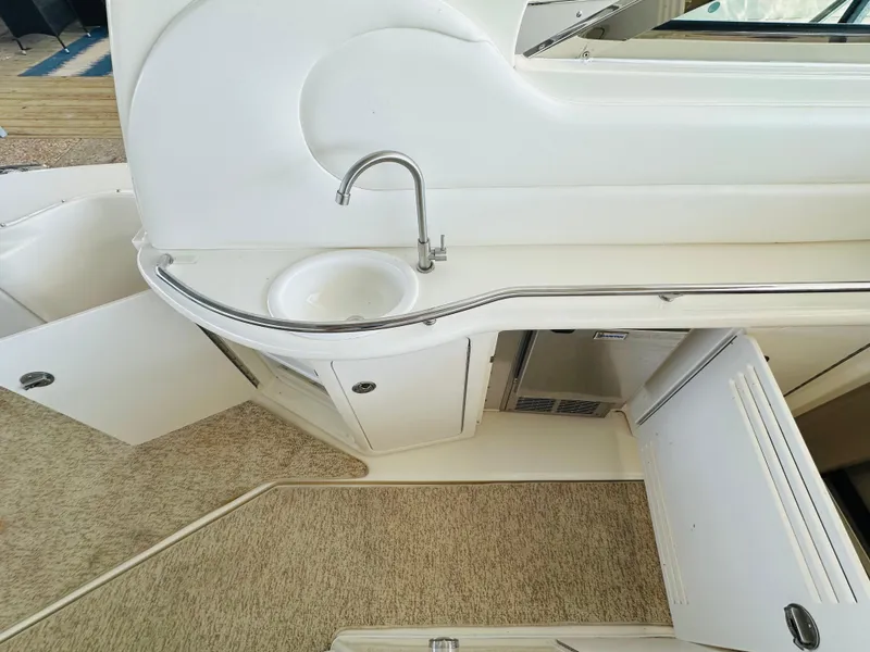Slide: The Image of Interior of 2002 Sea Ray 410 Express Cruiser with sink and storage cabinets. - 24