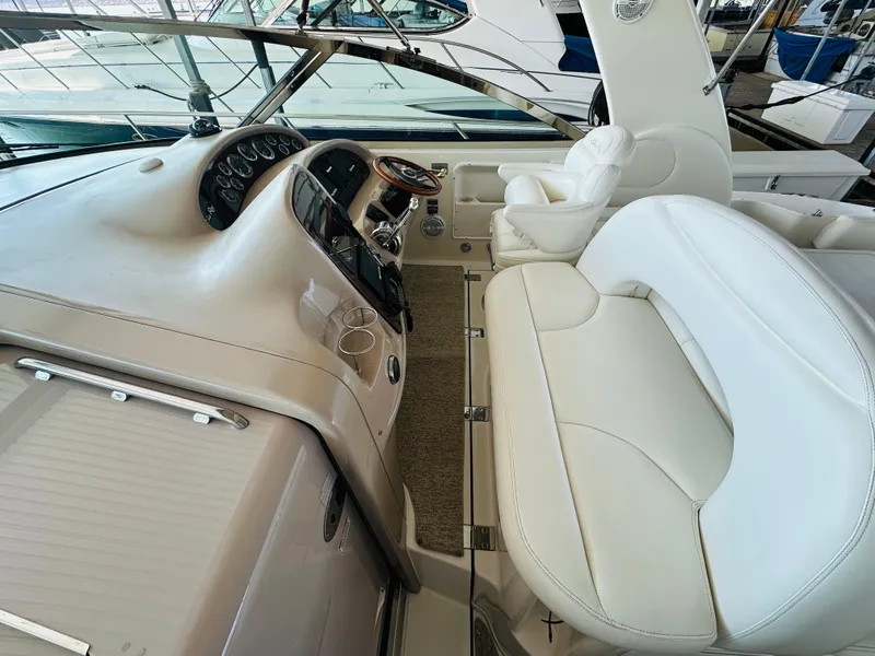 Slide: The Image of Interior view of 2002 Sea Ray 410 Express Cruiser with white leather seating. - 25
