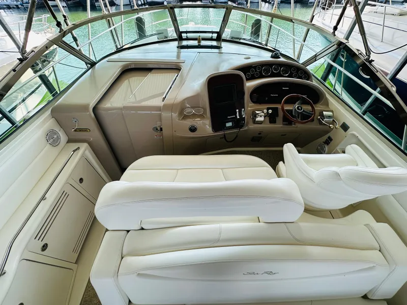 Slide: The Image of Interior of 2002 Sea Ray 410 Express Cruiser with white seating and helm controls. - 26