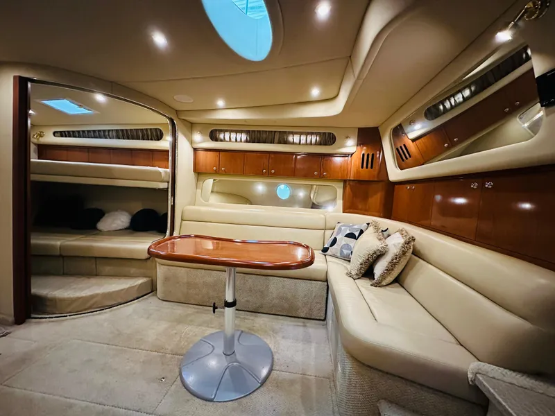 Slide: The Image of Luxurious interior of 2002 Sea Ray 410 Express Cruiser with elegant seating and table. - 30
