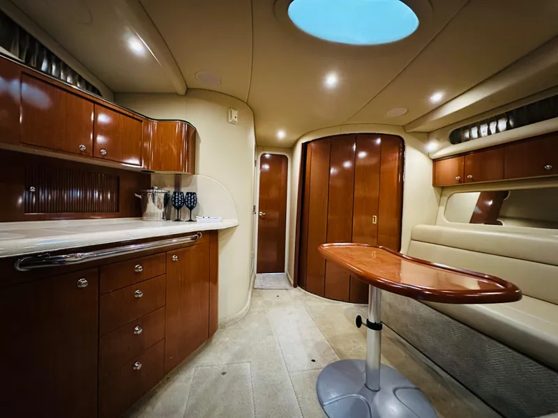 Slide: The Image of Luxurious interior of 2002 Sea Ray 410 Express Cruiser with elegant wood cabinetry. - 31