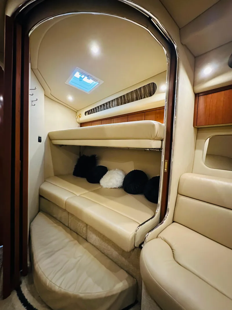 Slide: The Image of Interior cabin of 2002 Sea Ray 410 Express Cruiser with beige seating and cushions. - 33
