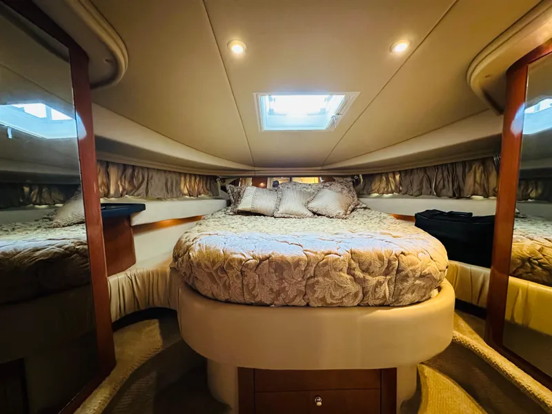 Slide: The Image of Luxurious cabin interior of 2002 Sea Ray 410 Express Cruiser with plush bedding. - 36
