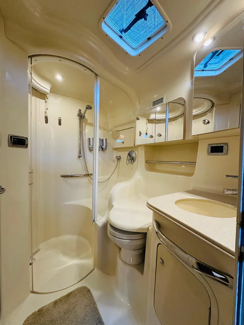 Slide: The Image of Luxurious bathroom in 2002 Sea Ray 410 Express Cruiser with modern fixtures and skylight. - 38