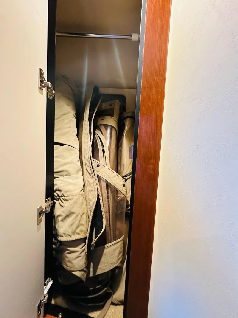 Slide: The Image of Storage closet on 2002 Sea Ray 410 Express Cruiser with folded chairs. - 39