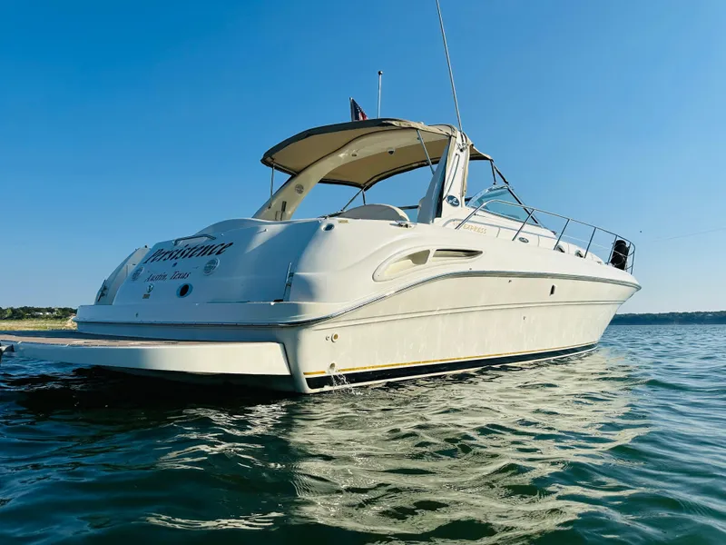 Slide: The Image of 2002 Sea Ray 410 Express Cruiser on calm water under clear blue sky. - 4