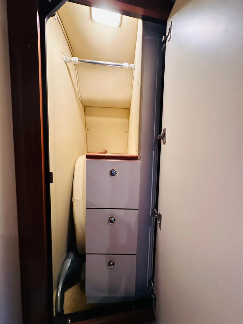 Slide: The Image of Interior closet of 2002 Sea Ray 410 Express Cruiser with storage drawers. - 40